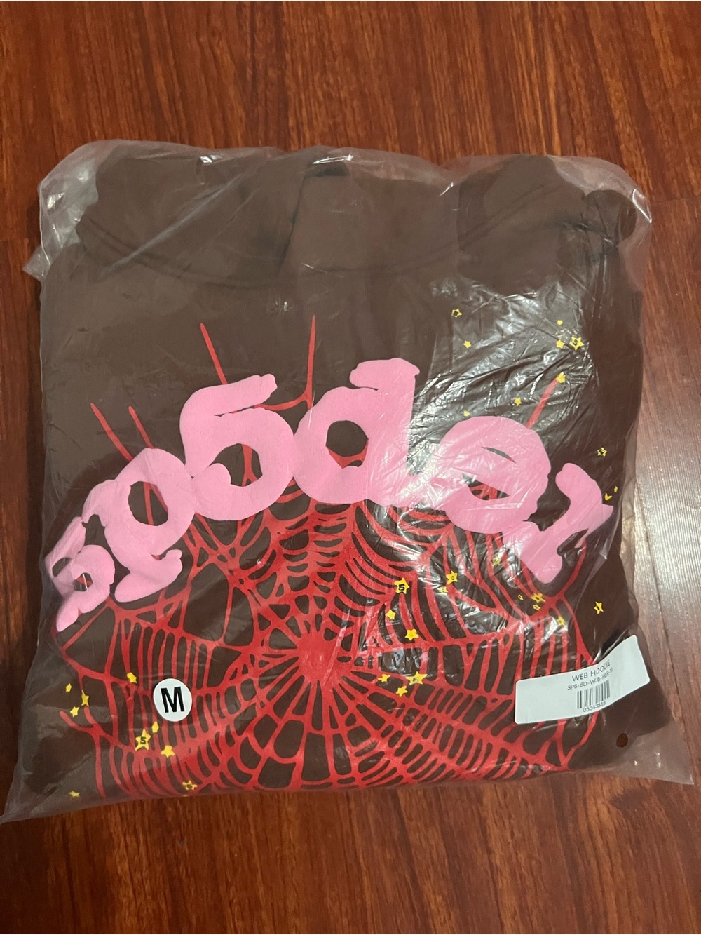 Brown Graphic Hoodie with Pink Logo and Red Web Design